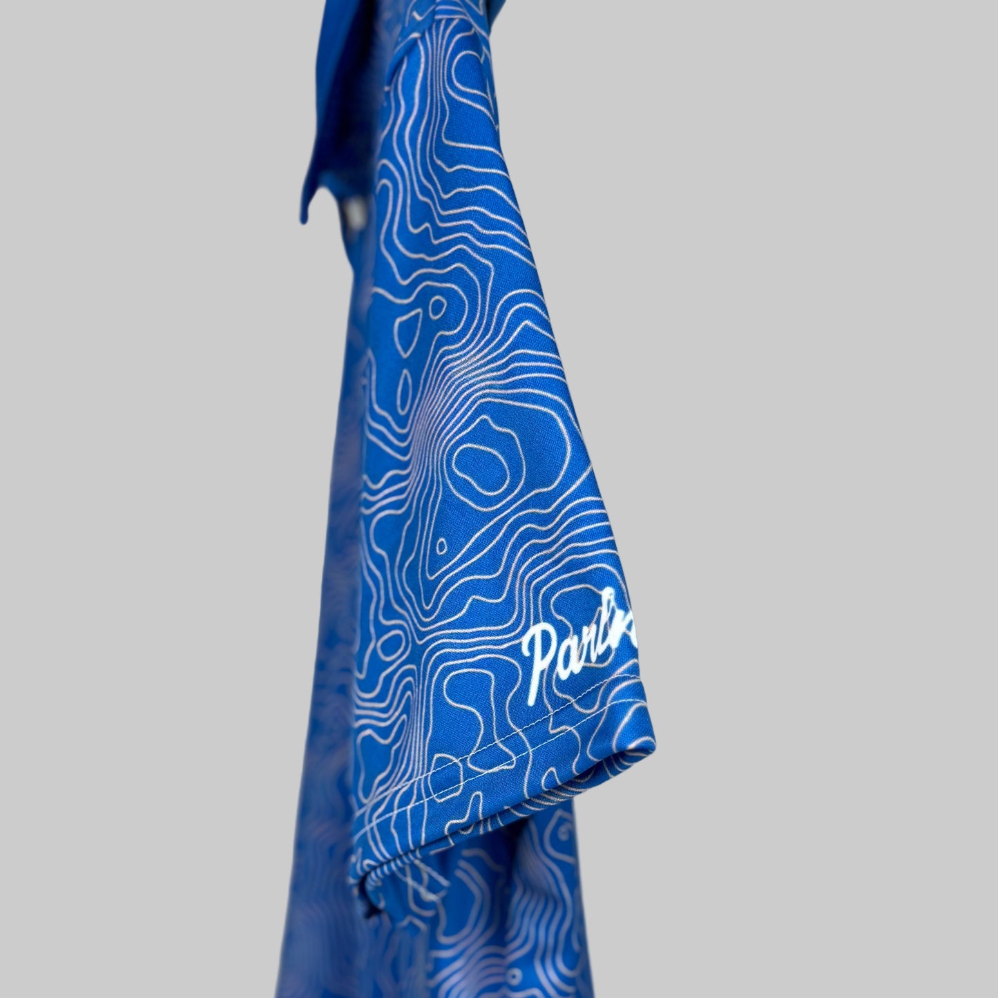 Blue towel with white pattern and 'Polar' branding on a white background