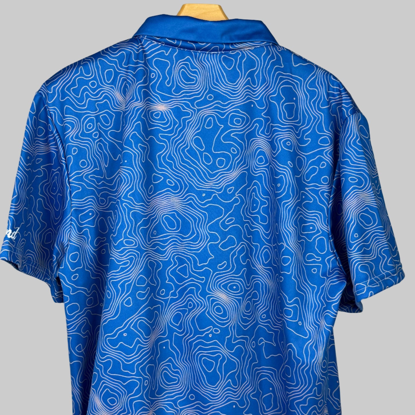 Blue patterned shirt on a mannequin against a white background
