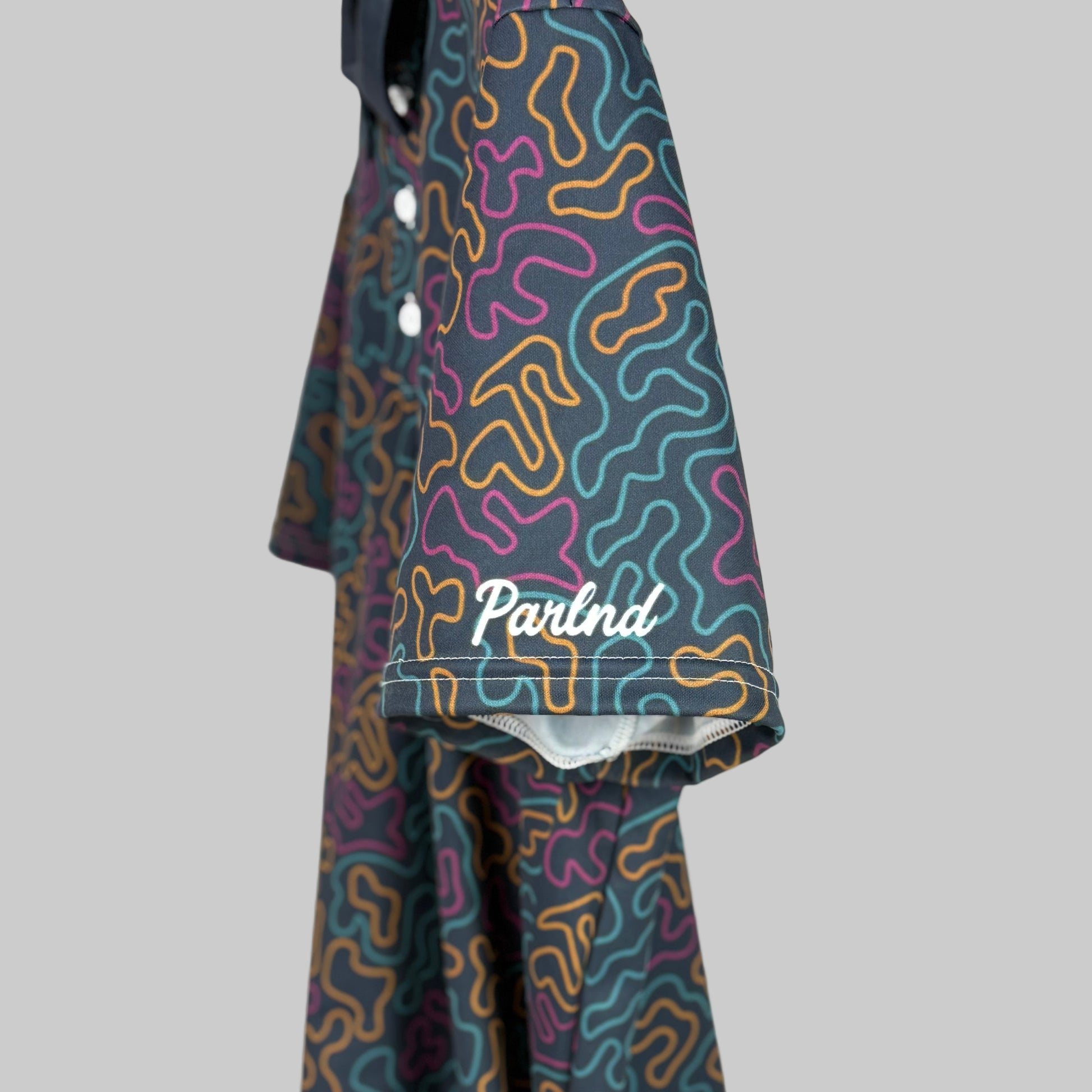 Colorful patterned pants with a brand logo on a white background