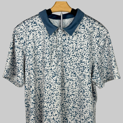 Floral-patterned shirt with blue collar on a hanger against a gray background