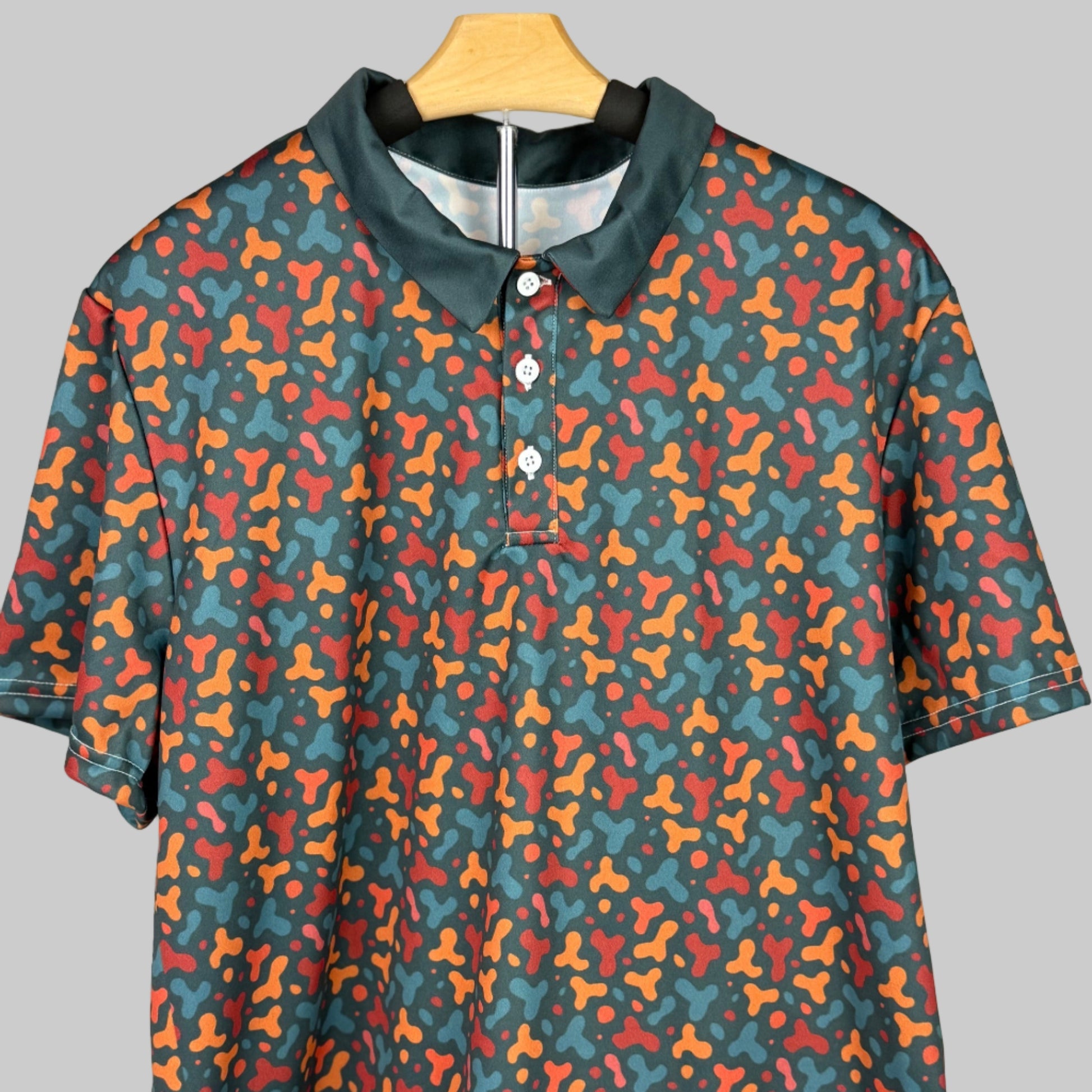 Colorful patterned shirt on a hanger against a white background