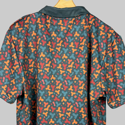 Colorful patterned shirt on a wooden hanger against a white background