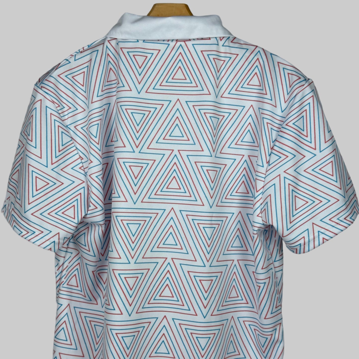 Short-sleeve shirt with geometric triangle pattern on a plain background
